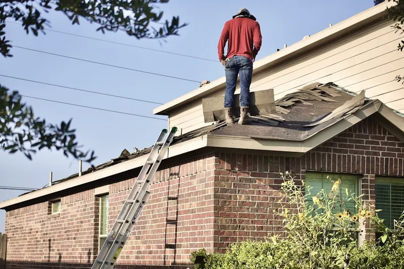 Professional roofer working on a residential roof in Poolesville